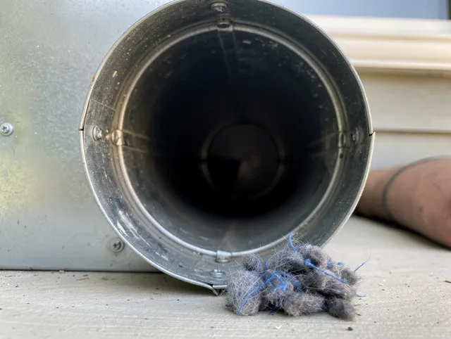 North Castle Dryer Vent Cleaning technician using specialized equipment to clear severe dryer vent blockage in North Castle